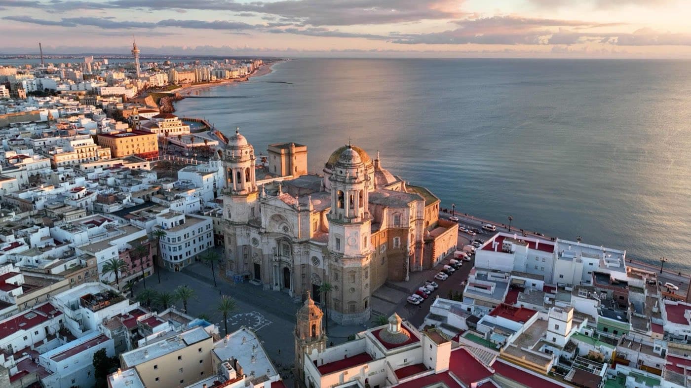 Bachata Week Cádiz 2026 — aerial view of Cádiz cathedral and the Atlantic at sunset