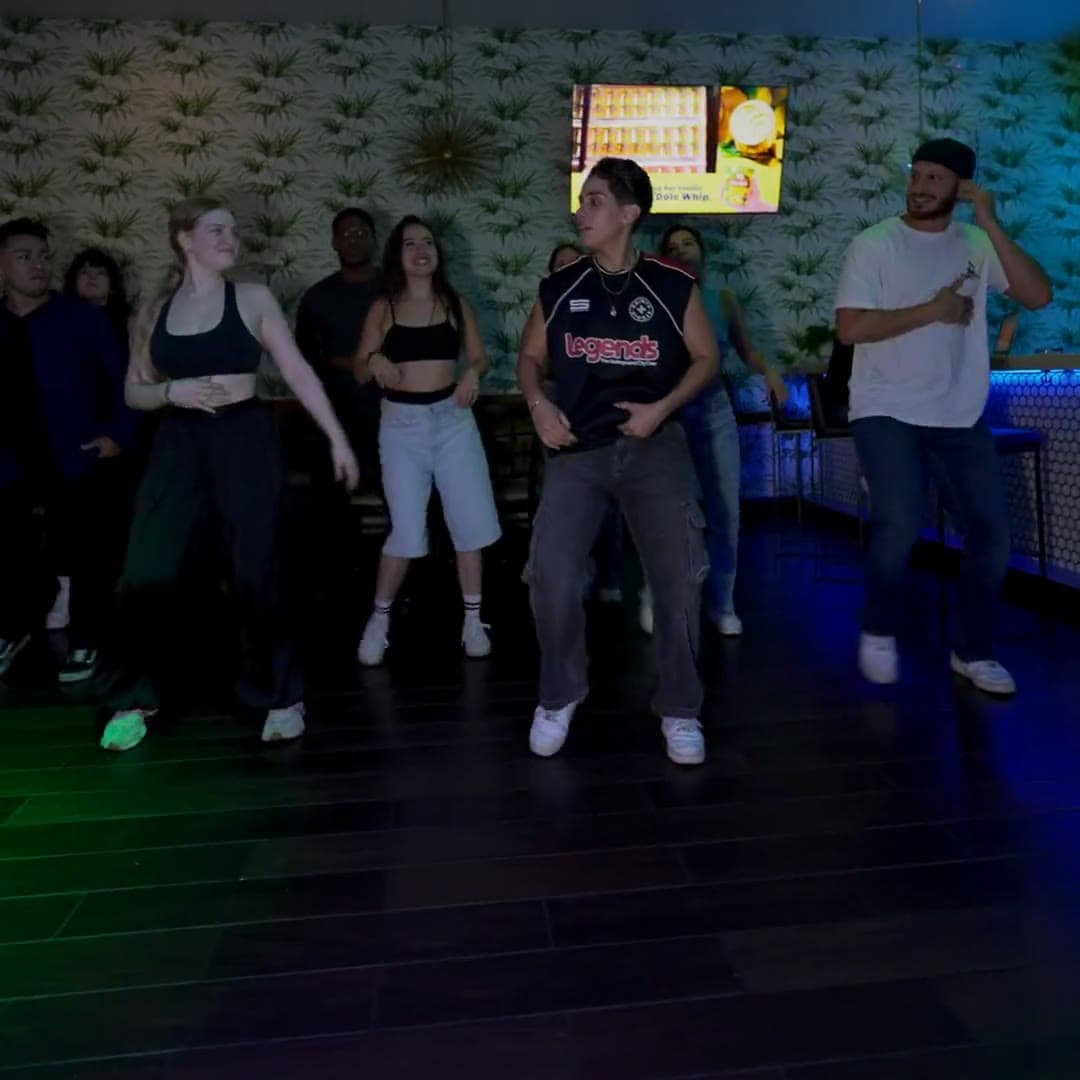 A bachata class dancing in lines in Orlando